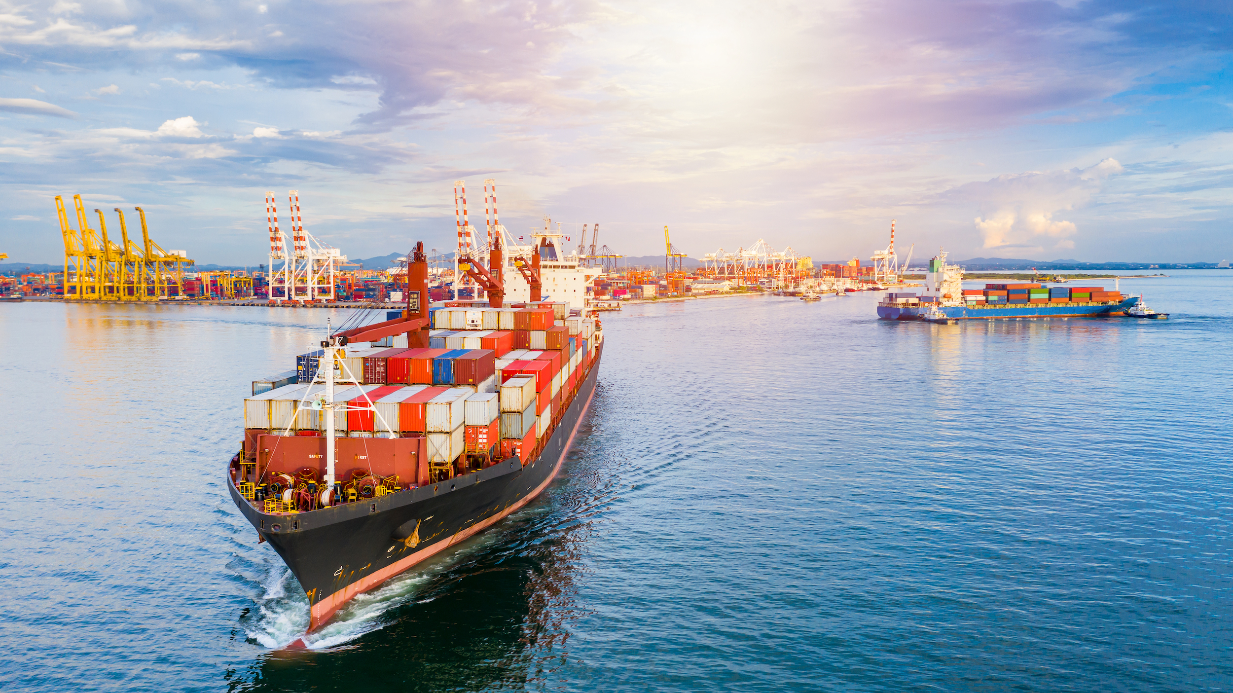 Container ship arriving at commercial port